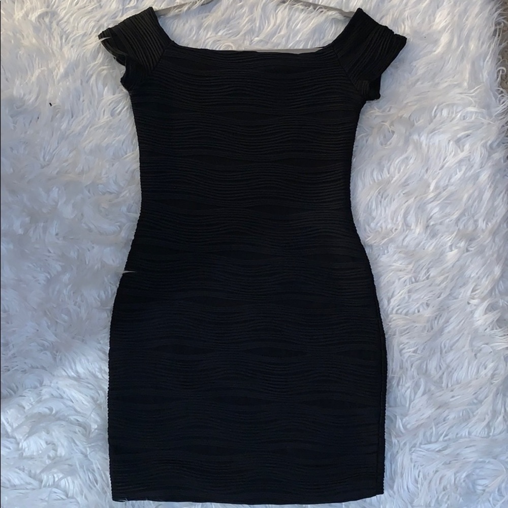 Black off shoulder bodycon dress.